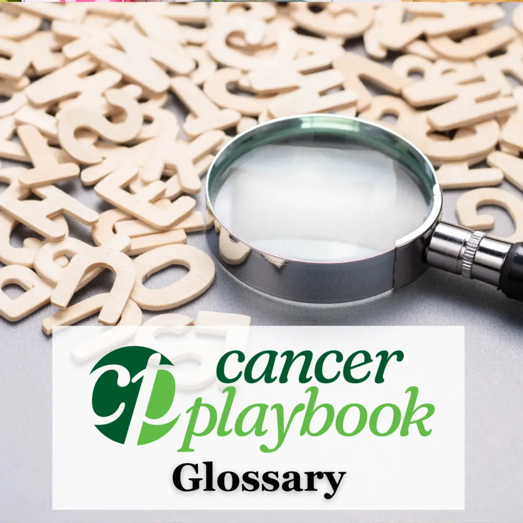Magnifying glass among letters made out of wood representing a Glossary
